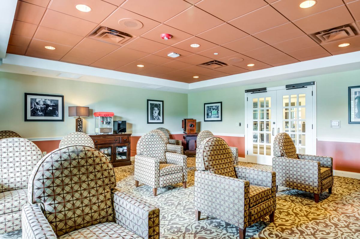 A cozy lounge area featuring patterned chairs and soft lighting.