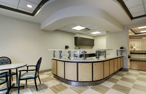 A modern reception area featuring a sleek counter and minimalistic design.