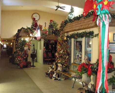 A festive indoor scene filled with Christmas decorations, including garlands and wreaths.