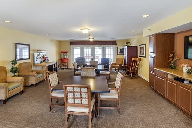 A cozy living room with arranged seating and tables.