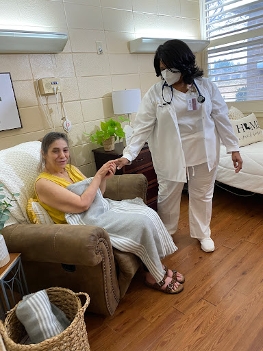 A nurse attends to a patient in a cozy clinic setting.