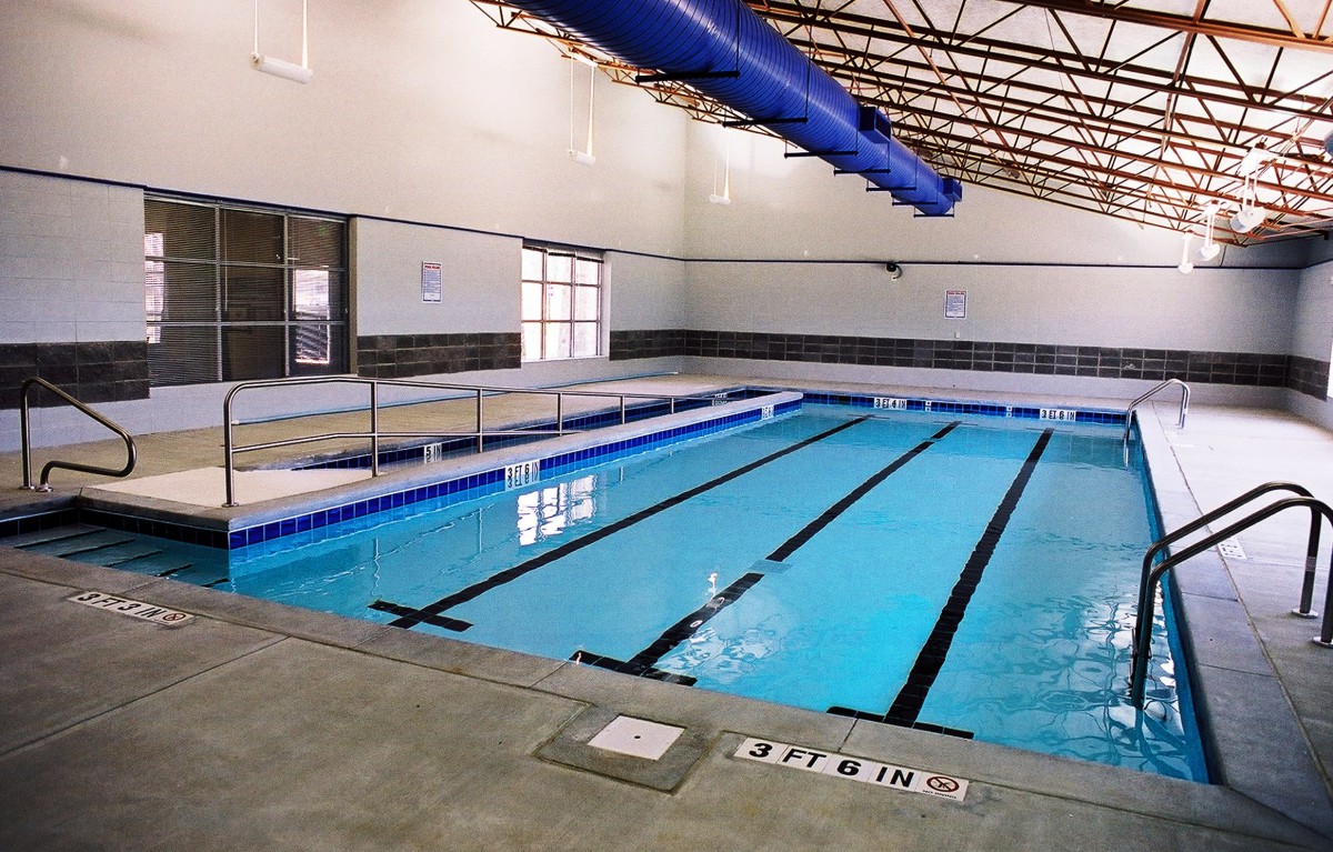An indoor swimming pool with multiple lanes for recreational and athletic use.