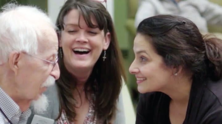 A group of people sharing a joyful conversation.