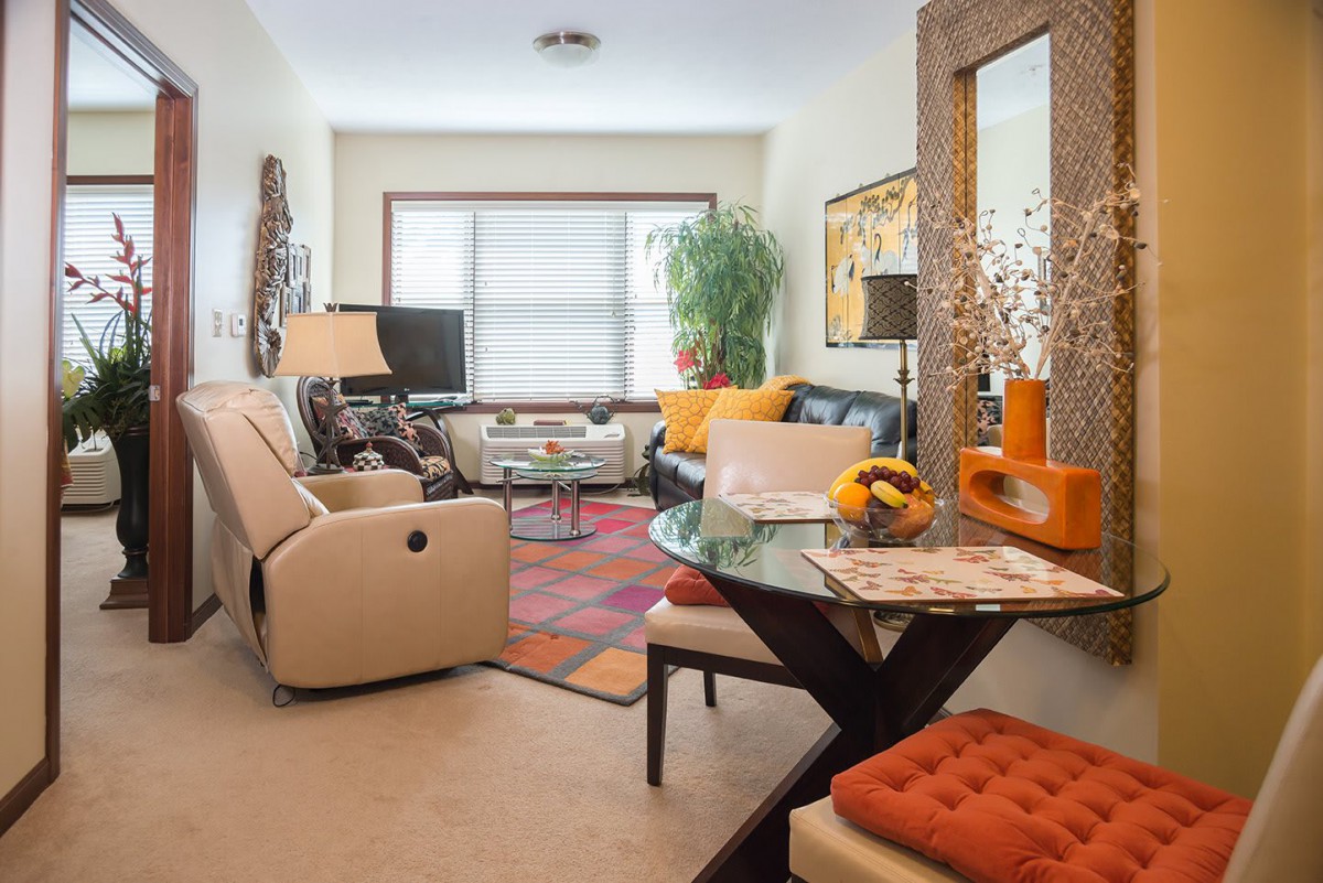A cozy living room featuring modern decor with bright colors and comfortable furniture.