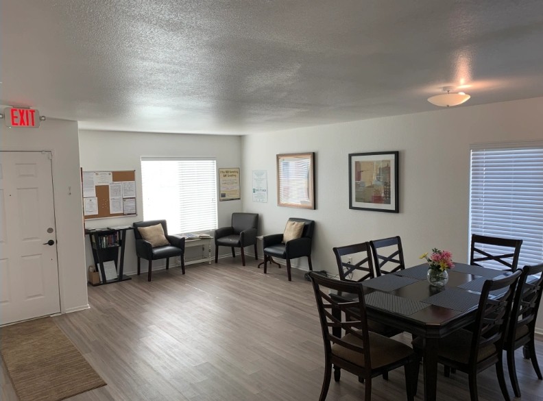 A modern living and dining area with stylish furnishings and bright lighting.