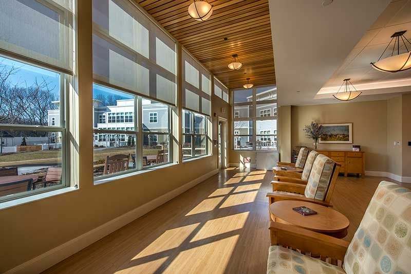 A bright and modern waiting area with large windows and comfortable seating.