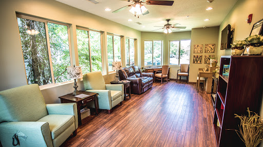 A bright and inviting lounge area with comfortable seating and large windows allowing natural light to fill the space.