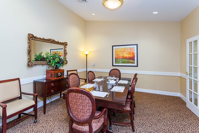 A cozy dining room with elegant furniture and tasteful decor.