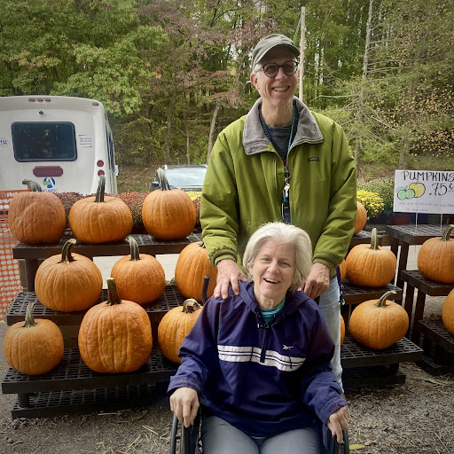 A cheerful moment among pumpkins, capturing the essence of fall.