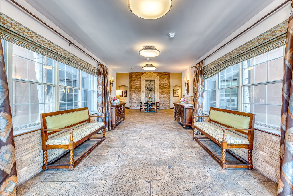 Spacious hallway with seating and large windows.