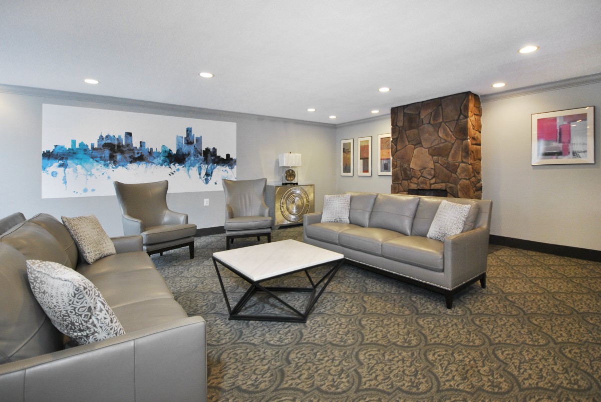 A modern living room with stylish furniture and contemporary artwork on the walls.