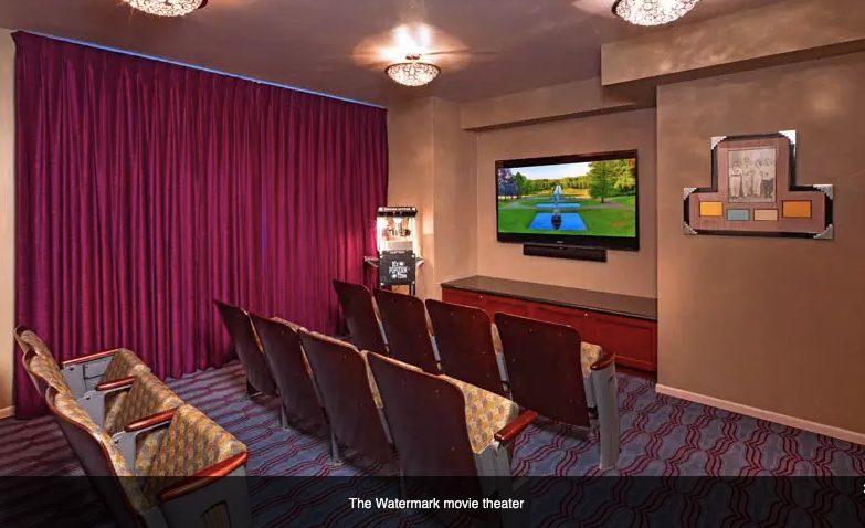 A cozy home theater with comfortable seating and a large screen.