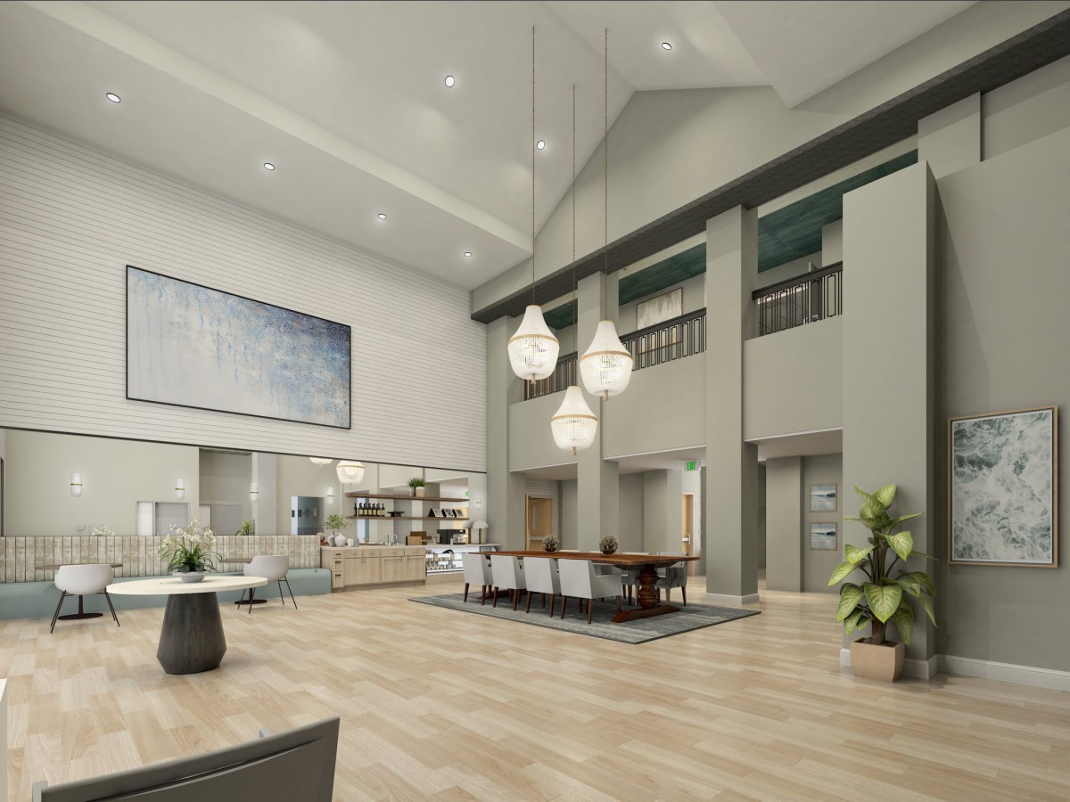 A modern and spacious lobby featuring elegant lighting fixtures, a reception desk, elevators, and decorative plants.
