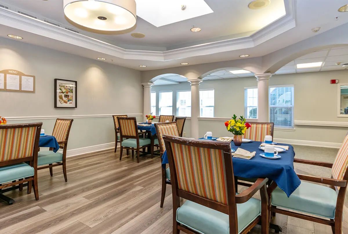 A well-lit dining area with neatly arranged tables and elegant decor.