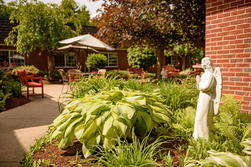 A serene garden area featuring lush plants and outdoor seating, perfect for relaxation.