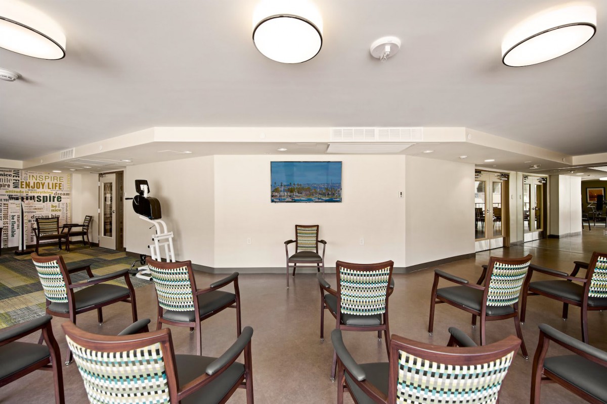 An empty waiting room with chairs arranged in a circle and minimalist decor.