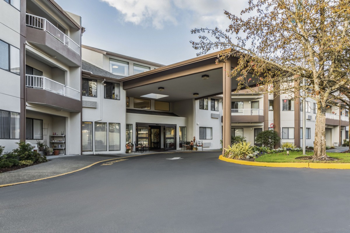 A residential building entrance with a covered driveway area.
