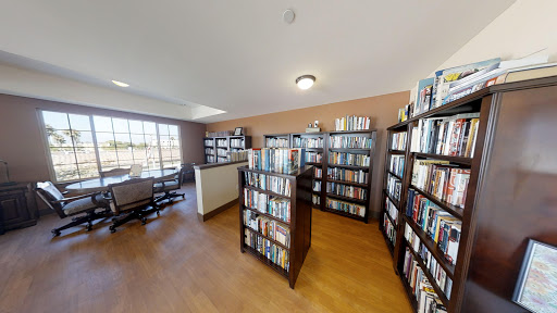 A cozy library filled with books, providing a perfect spot for reading and relaxation.