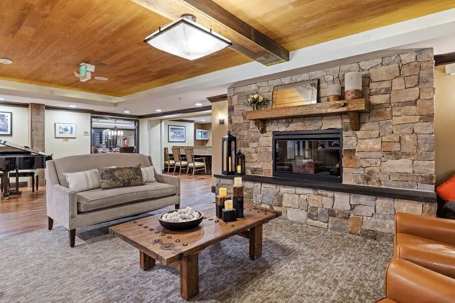 Cozy living room with a stone fireplace and modern decor.