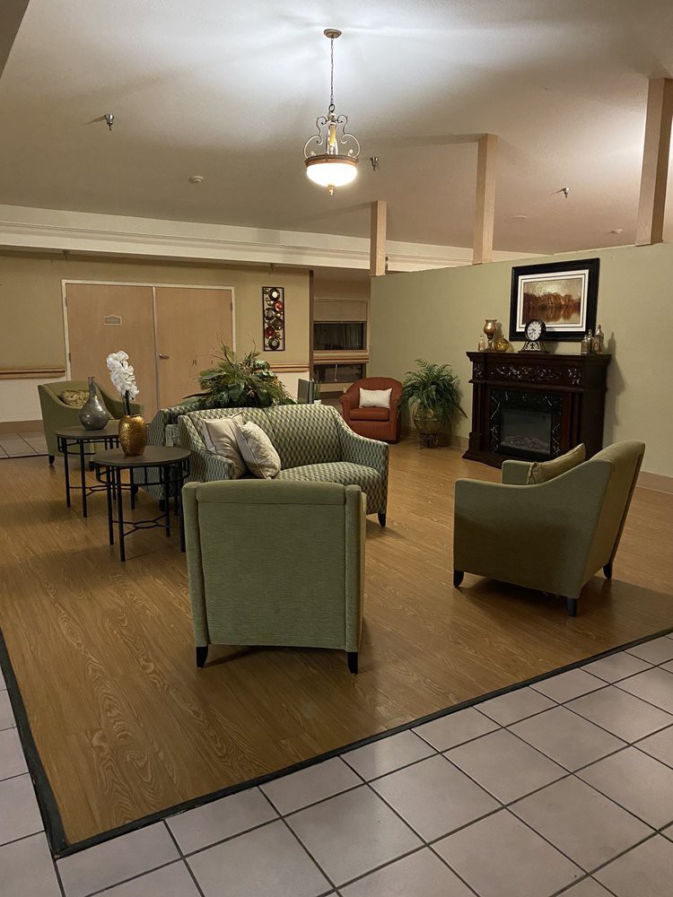 A cozy living room with comfortable seating and a fireplace.