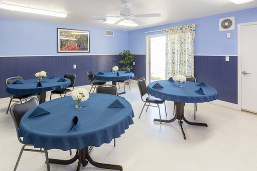 A well-decorated dining area featuring blue tablecloths and a bright, inviting atmosphere.