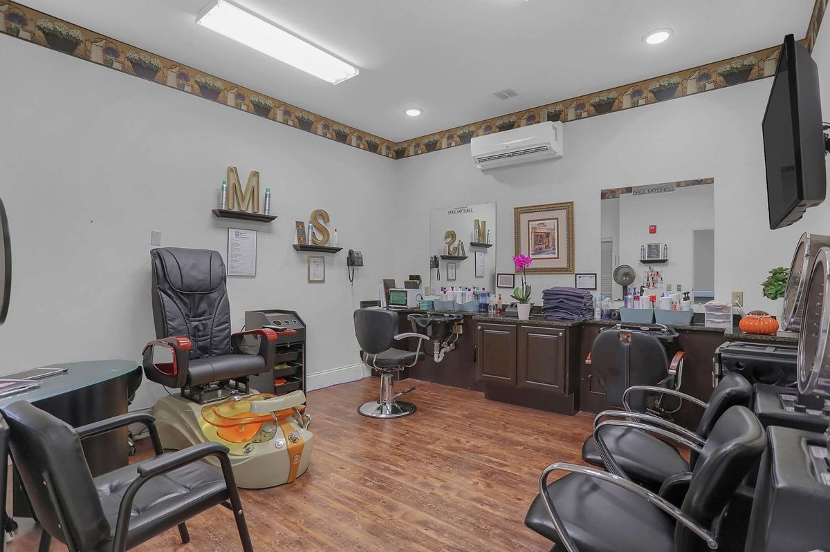 Interior of a beauty salon with styling chairs and mirrors.