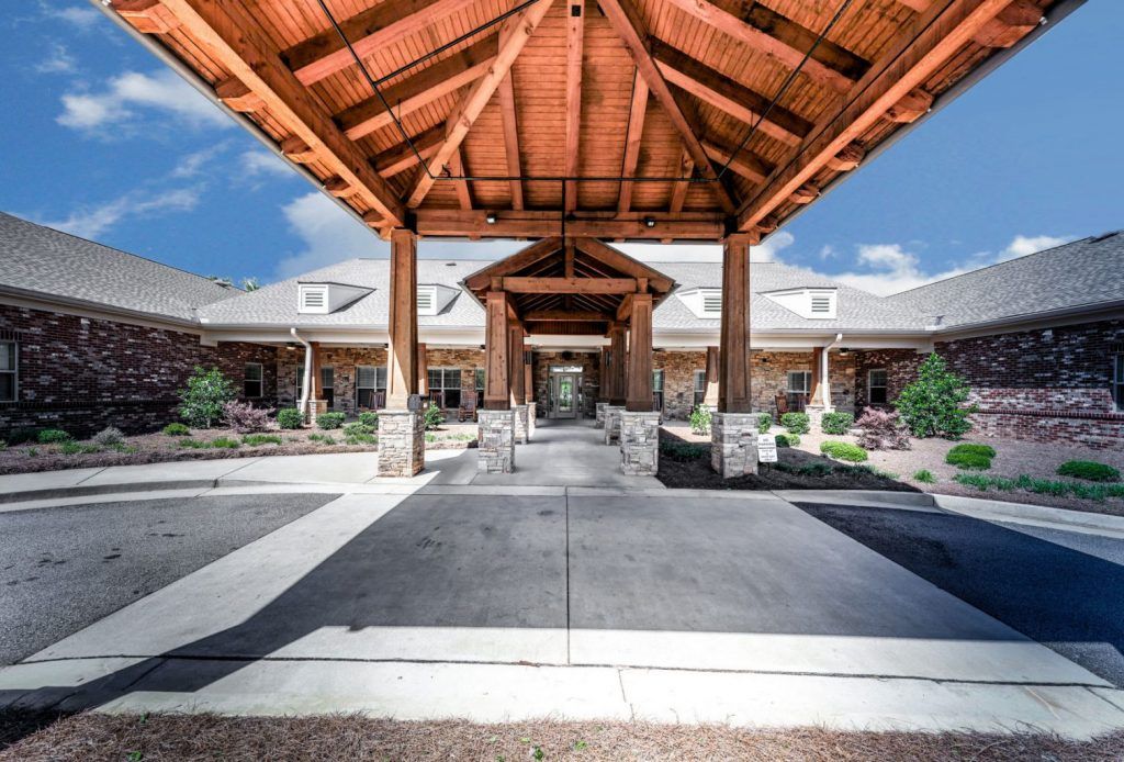 A beautiful wooden entrance with a covered walkway leading to a large building.