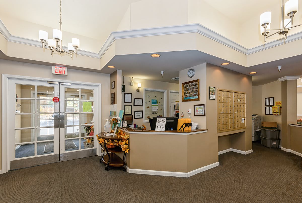 The image shows a reception area with a desk and various decorations, typical of an office lobby.