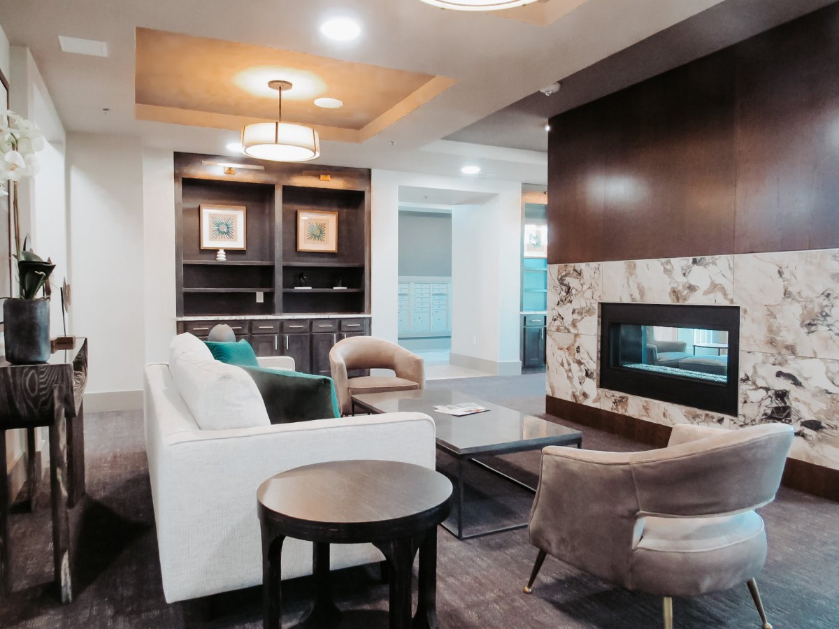 A modern living room featuring a cozy seating area with a fireplace and stylish decor.