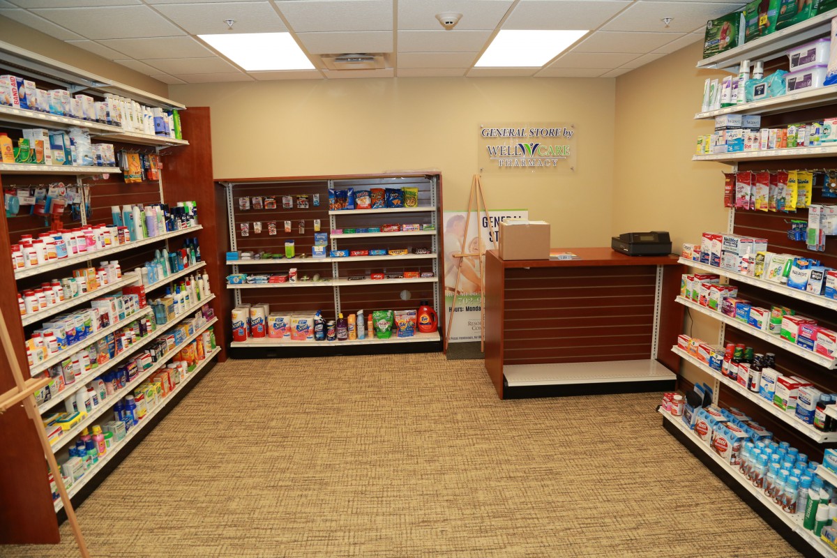 Interior view of a pharmacy store with neatly organized shelves and a counter.