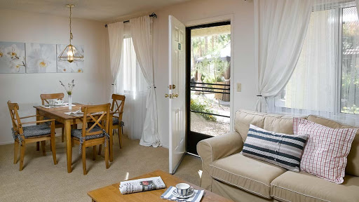 A cozy living space with natural light streaming through the open doorway.