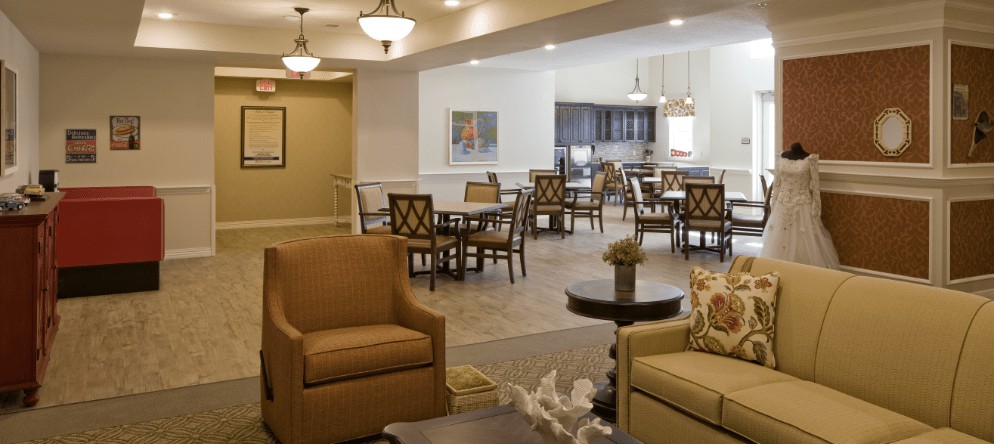 A cozy interior with a lounge and dining area featuring comfortable seating and warm lighting.