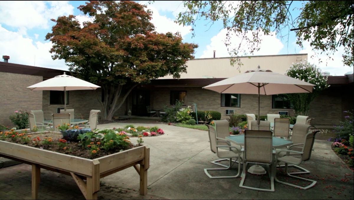 A peaceful patio area with outdoor furniture and garden plants.