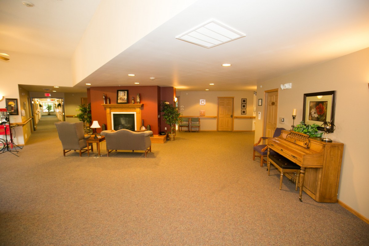 A cozy lobby area featuring comfortable seating and a fireplace.