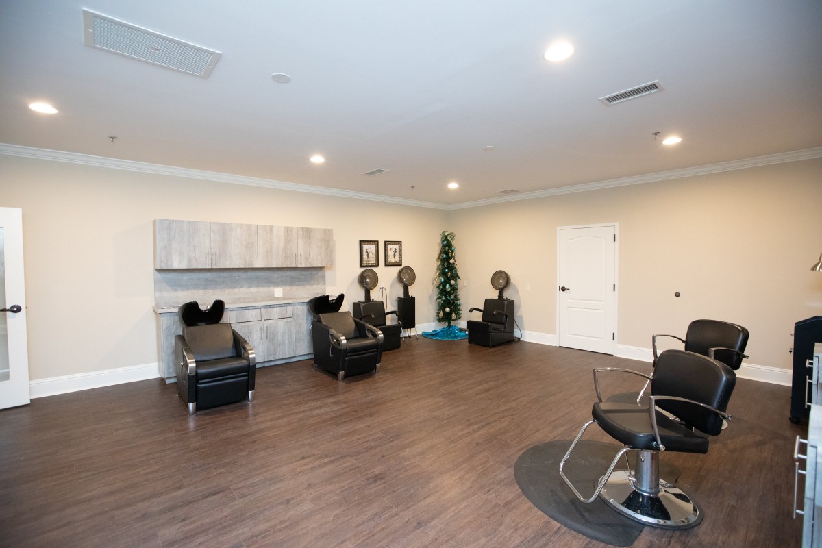 A modern salon interior with styling chairs and hairdryers.