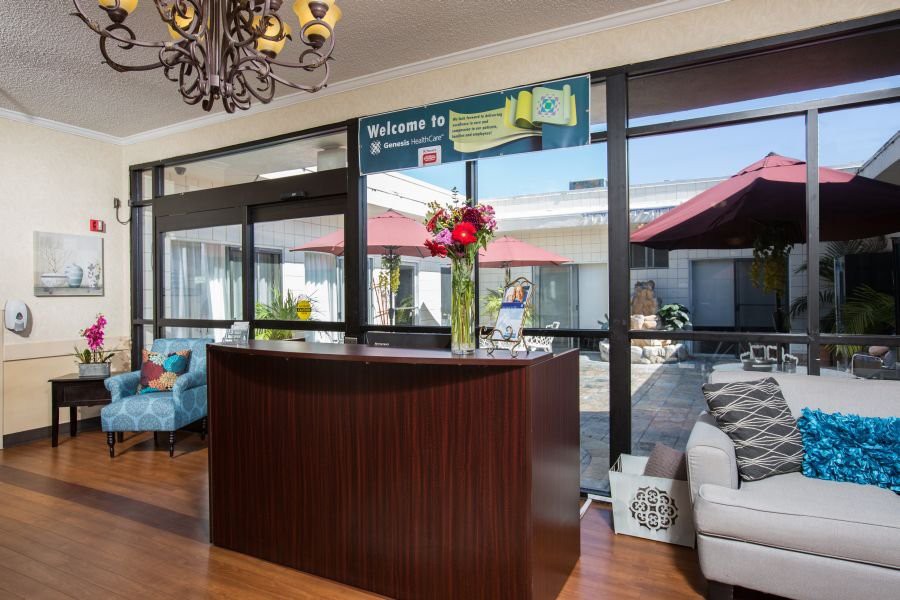 A modern reception area with a welcoming desk and floral arrangement.