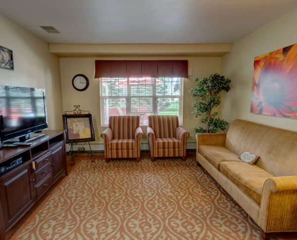 A cozy living room with comfortable seating and a television.