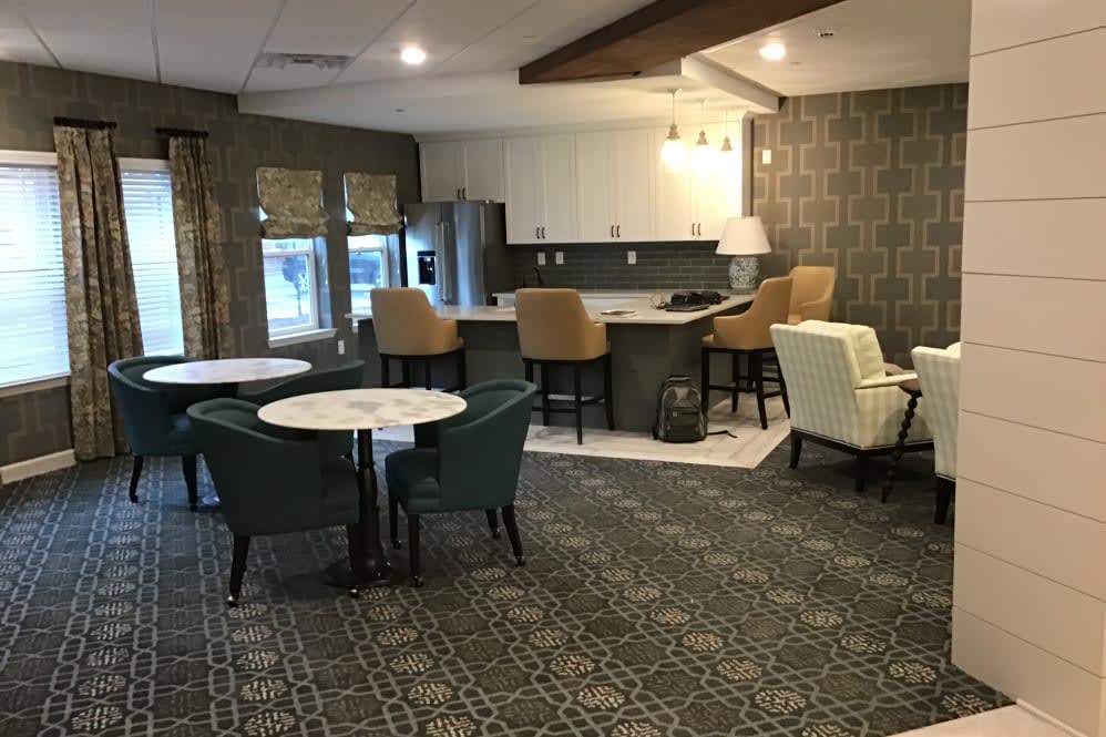 A modern open-concept living room and kitchen with stylish furniture and decor.