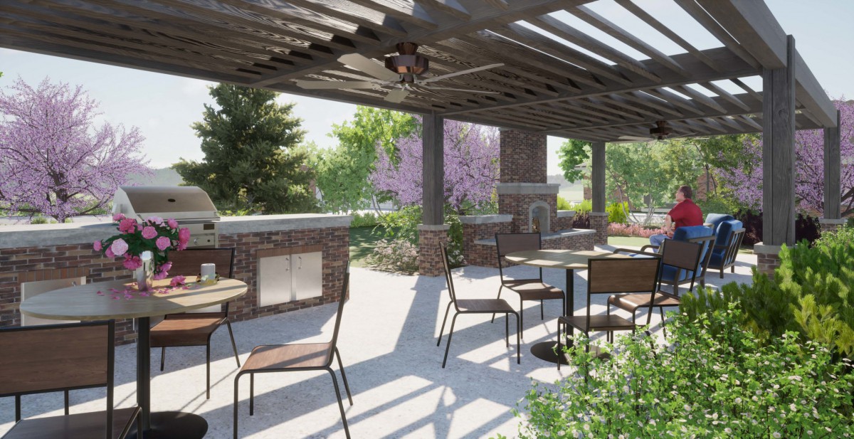 A sunny outdoor patio with a pergola, featuring tables and chairs surrounded by lush greenery.