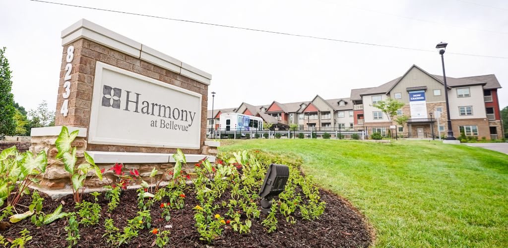 A residential complex with a sign reading 'Harmony at Rutherford', surrounded by landscaped gardens.