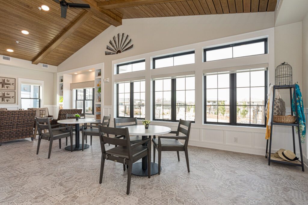 A modern dining area with large windows and abundant natural light.