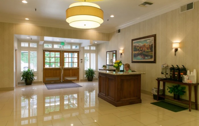 A well-lit lobby with a reception desk and modern decor.