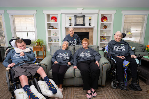 A warm gathering of residents in a care facility, showcasing camaraderie and comfort.