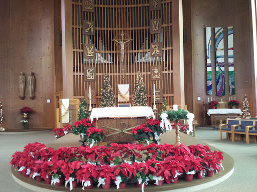 A beautifully decorated church altar adorned with festive poinsettias for the Christmas season.
