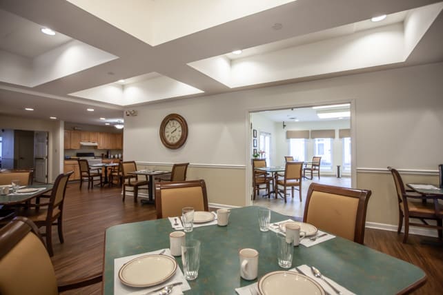 A neatly arranged dining area with several tables and chairs, ready for guests.