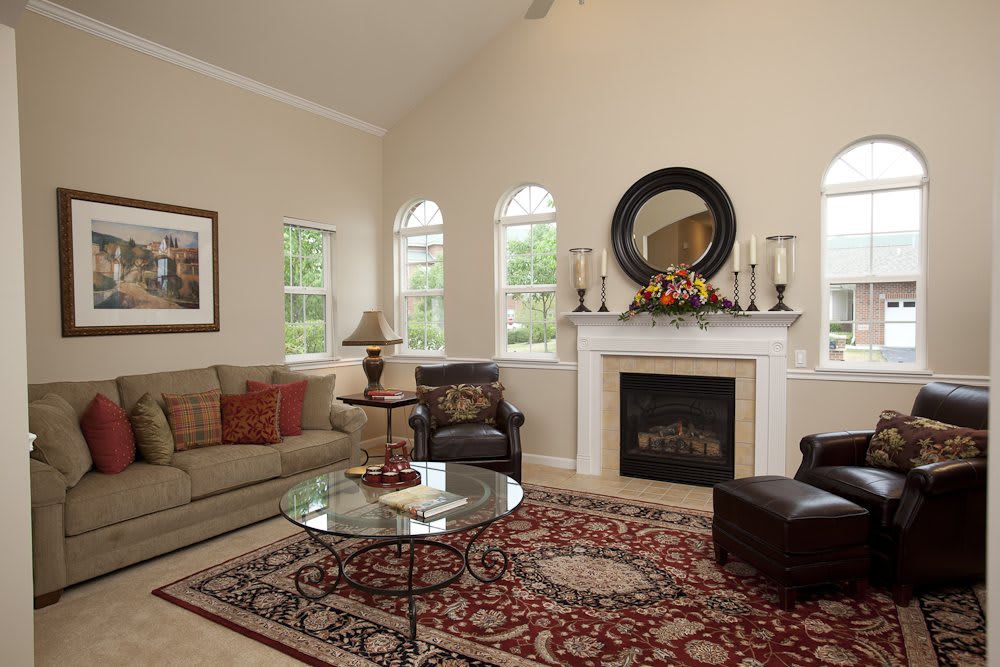 A cozy and elegant living room with a fireplace, sofa, and stylish decor.