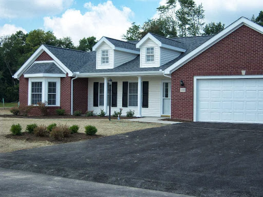 A charming single-story house with a brick exterior and a well-maintained driveway.