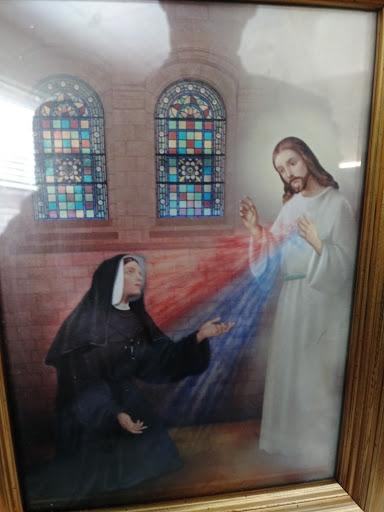 A depiction of Jesus interacting with a saint in a church setting.