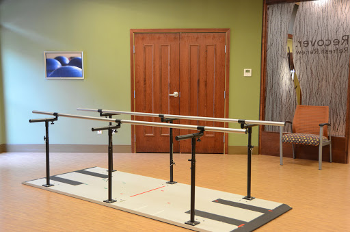 A ballet barre setup in a studio space, featuring multiple bars for training.