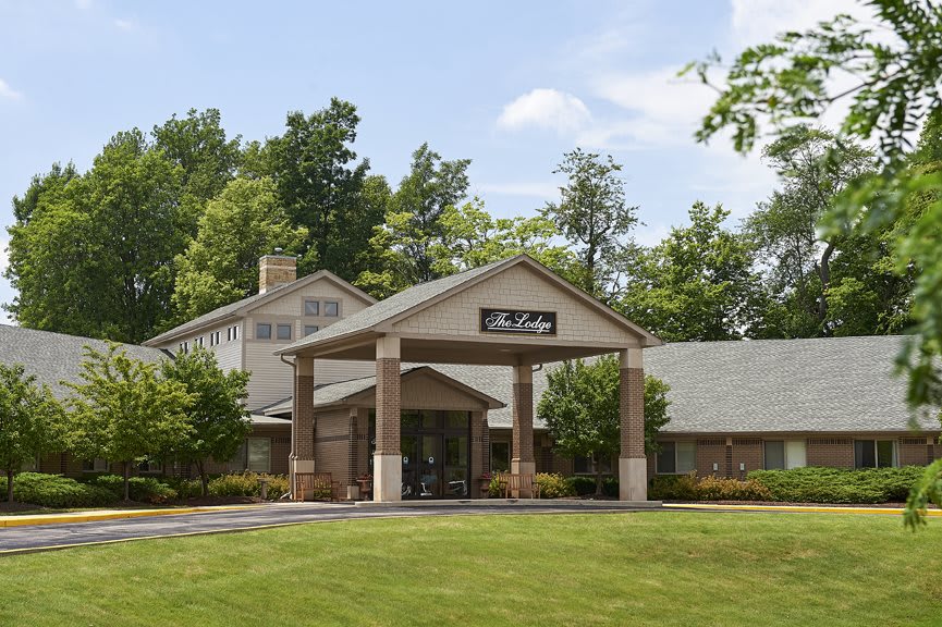 A view of a building surrounded by trees and greenery.